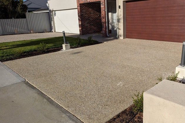 Detailed view of exposed aggregate surface showing various coloured stones and pebbles